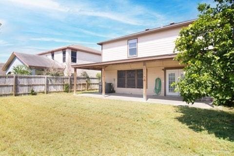 back of house with a lawn