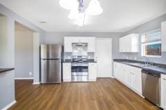 kitchen featuring white cabinets, ceiling fan, stainless steel appliances, and dark wood-type flooring