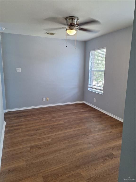 empty room featuring dark hardwood / wood-style floors and ceiling fan