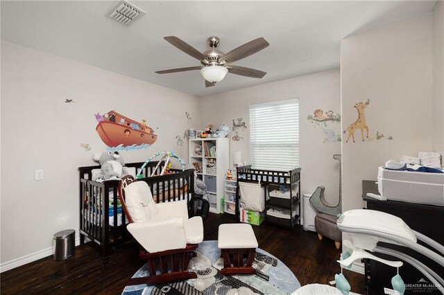 bedroom with dark hardwood / wood-style floors and ceiling fan