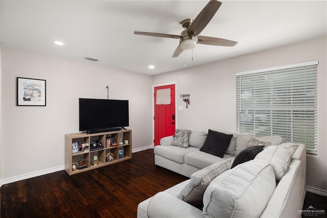 living room featuring ceiling fan and dark hardwood / wood-style floors