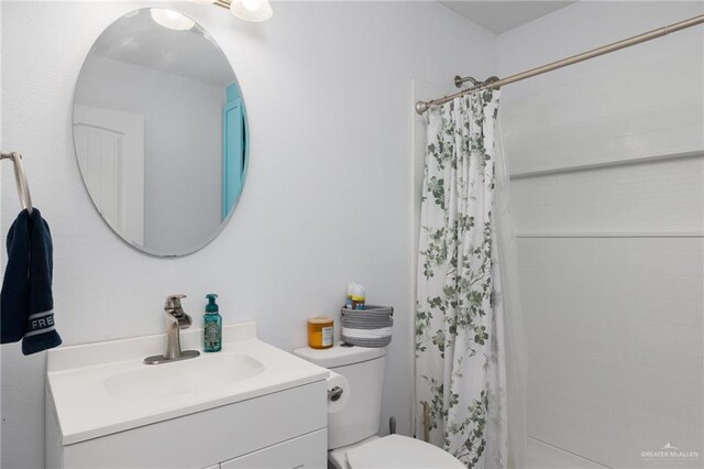 bathroom with vanity, toilet, and a shower with shower curtain