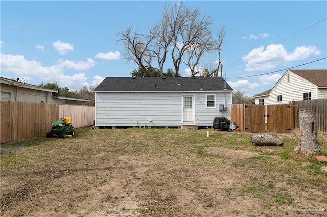 rear view of house with a yard