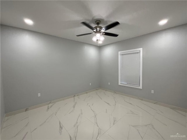 unfurnished room featuring marble finish floor, a ceiling fan, recessed lighting, and baseboards