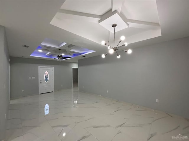 unfurnished room with visible vents, a tray ceiling, coffered ceiling, beam ceiling, and a notable chandelier