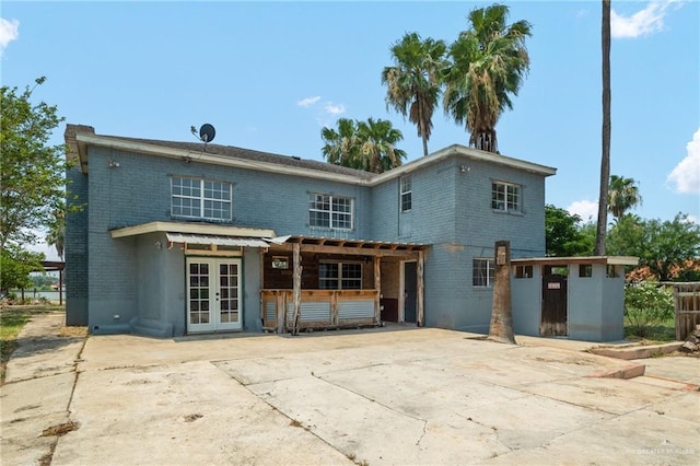 rear view of house with french doors and a patio