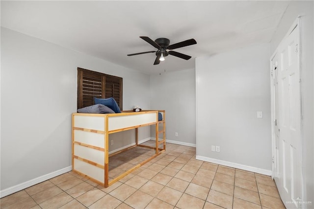 unfurnished bedroom with light tile patterned floors and ceiling fan