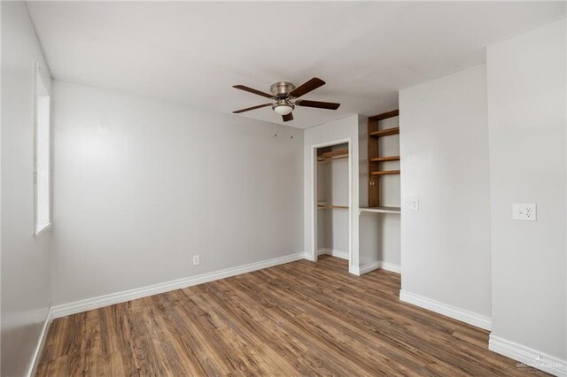 unfurnished bedroom with ceiling fan, dark hardwood / wood-style flooring, and a closet