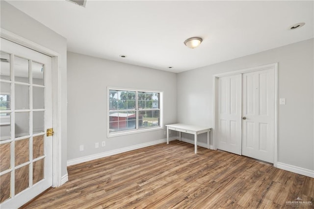 spare room with hardwood / wood-style flooring