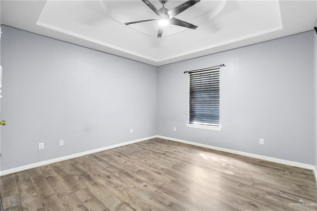 1411 Dons Dr, Mission, TX 78572 - empty room with a raised ceiling, baseboards, and wood finished floors