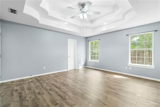 1411 Dons Dr, Mission, TX 78572 - empty room with a tray ceiling, wood finished floors, a ceiling fan, baseboards, and recessed lighting