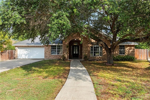 1411 Dons Dr, Mission, TX 78572 - view of front of home featuring a garage, driveway, and brick siding