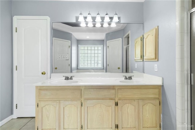 1411 Dons Dr, Mission, TX 78572 - full bathroom with double vanity, tile patterned floors, a shower with door, and baseboards