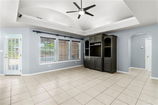 1411 Dons Dr, Mission, TX 78572 - unfurnished living room featuring arched walkways, a ceiling fan, baseboards, vaulted ceiling, and light tile patterned floors