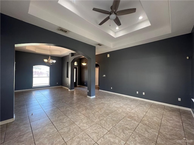 2700 Duke Ave, Mcallen, TX 78504 - empty room with a tray ceiling, arched walkways, ceiling fan, light tile patterned flooring, and a chandelier