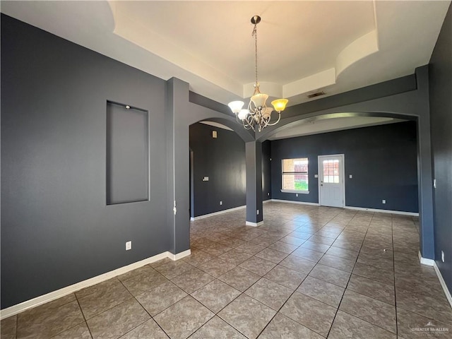 2700 Duke Ave, Mcallen, TX 78504 - empty room featuring arched walkways, a raised ceiling, a chandelier, tile patterned flooring, and baseboards
