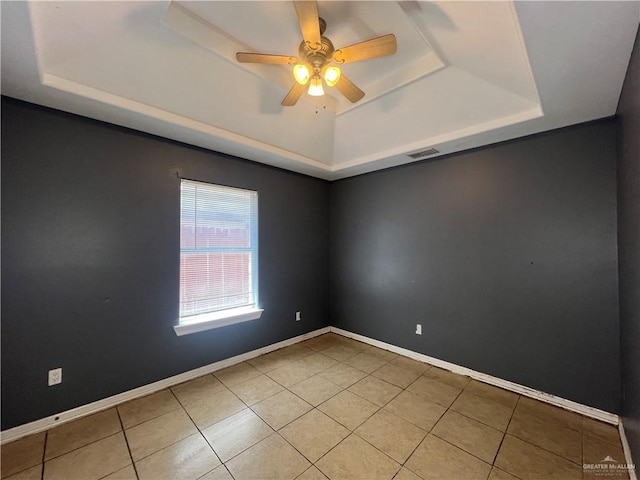 2700 Duke Ave, Mcallen, TX 78504 - tiled empty room featuring a tray ceiling, a ceiling fan, and baseboards