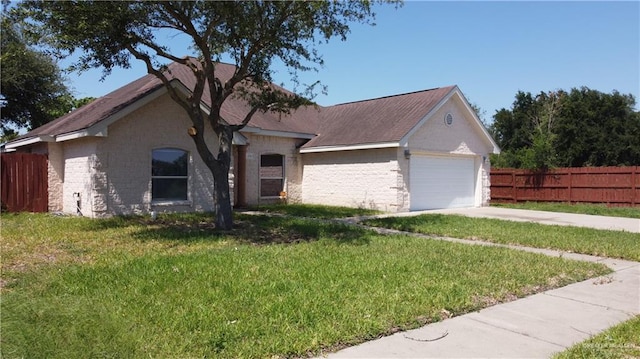 2700 Duke Ave, Mcallen, TX 78504 - view of front facade featuring a garage, stone siding, and driveway