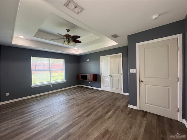 2700 Duke Ave, Mcallen, TX 78504 - unfurnished bedroom with a raised ceiling, baseboards, dark wood-style floors, a closet, and ceiling fan