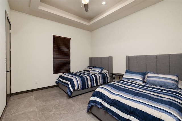 bedroom featuring a tray ceiling, baseboards, ceiling fan, and recessed lighting