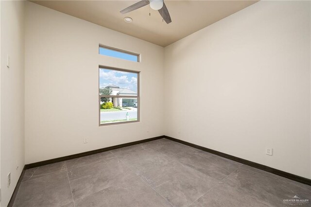 unfurnished room with baseboards and a ceiling fan