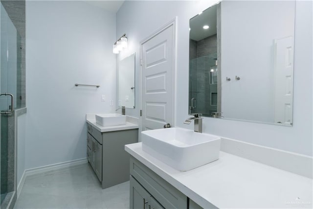 bathroom featuring a shower with door and vanity