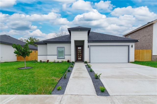 view of front of home with a front lawn and a garage