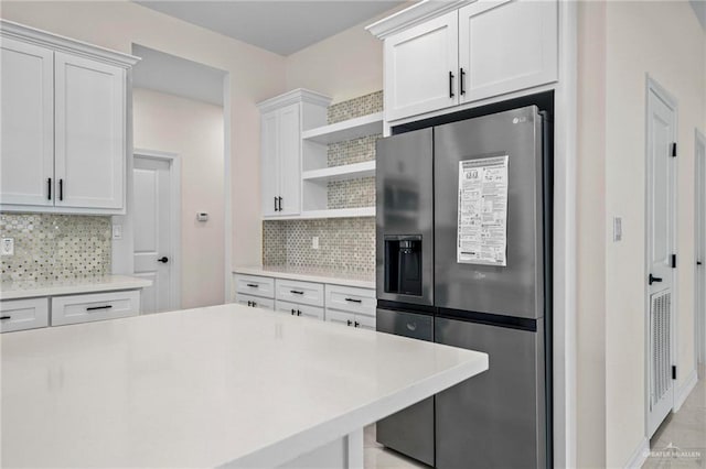 1809 Diplomat Dr, Edinburg, TX 78542 - kitchen with freestanding refrigerator, open shelves, decorative backsplash, and light countertops
