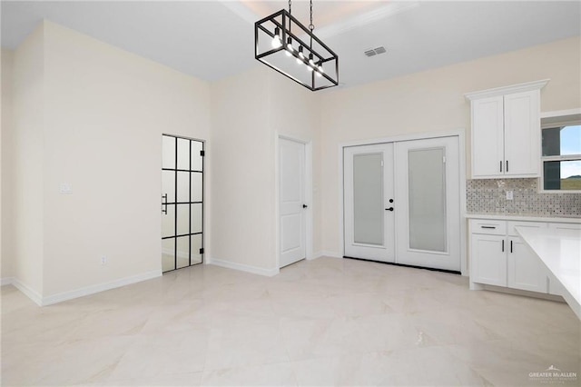 1809 Diplomat Dr, Edinburg, TX 78542 - unfurnished dining area featuring baseboards, an inviting chandelier, french doors, and visible vents