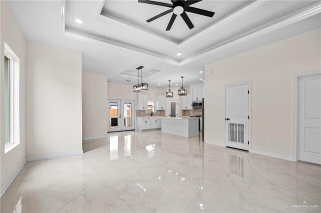1809 Diplomat Dr, Edinburg, TX 78542 - unfurnished living room featuring a ceiling fan, baseboards, and a tray ceiling