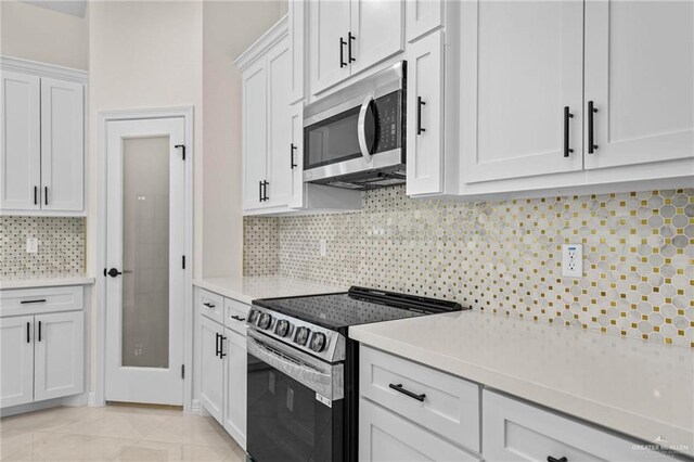 1809 Diplomat Dr, Edinburg, TX 78542 - kitchen featuring white cabinets, light countertops, appliances with stainless steel finishes, and tasteful backsplash