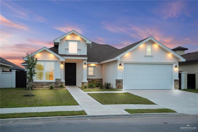 1809 Diplomat Dr, Edinburg, TX 78542 - traditional-style home with stone siding, concrete driveway, a garage, stucco siding, and a lawn