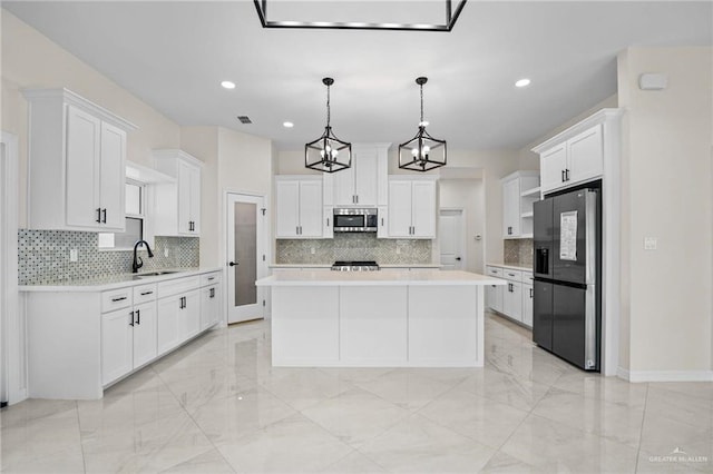 1809 Diplomat Dr, Edinburg, TX 78542 - kitchen with stainless steel microwave, a sink, marble finish floor, black fridge, and light countertops