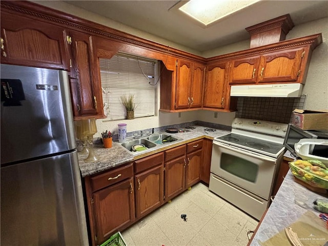 kitchen with stainless steel fridge, white range with electric stovetop, and sink