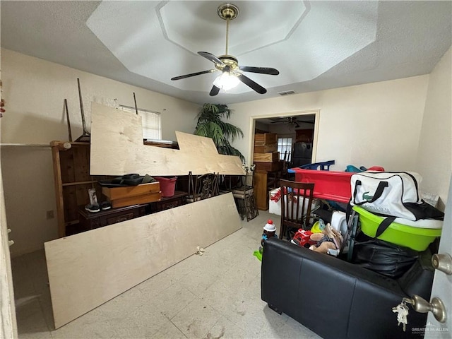 interior space featuring ceiling fan and a textured ceiling