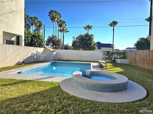 view of pool featuring a lawn and an in ground hot tub