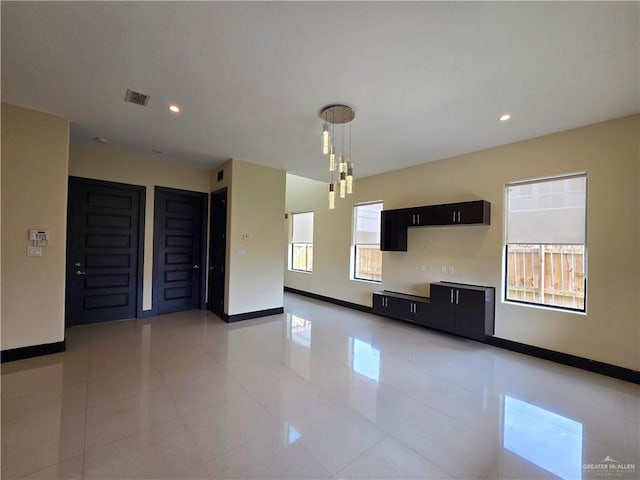 unfurnished living room featuring light tile patterned flooring