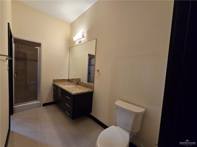 bathroom featuring tile patterned floors, vanity, toilet, and a shower with shower door