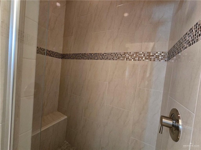 bathroom with tiled shower