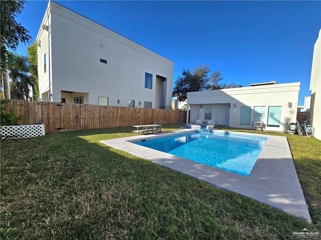 view of swimming pool featuring cooling unit and a yard