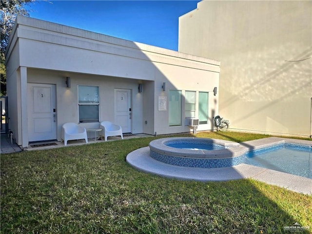 rear view of house featuring a swimming pool with hot tub and a lawn