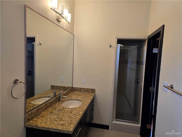 bathroom with vanity and a shower with door