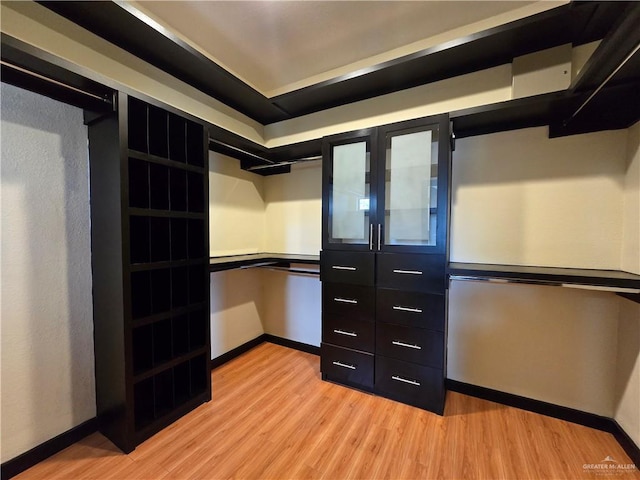 spacious closet with light hardwood / wood-style floors