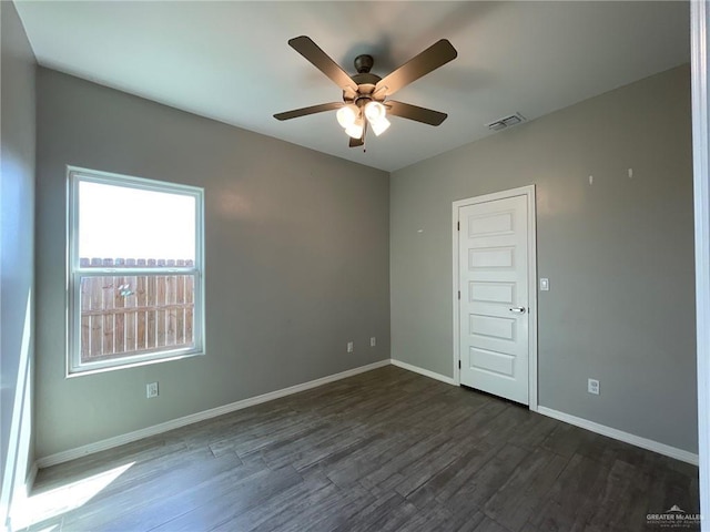 2108 Davenport St, Weslaco, TX 78596 - spare room featuring dark wood-type flooring, ceiling fan, and baseboards