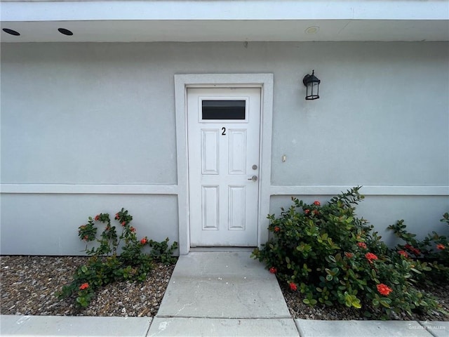 2108 Davenport St, Weslaco, TX 78596 - doorway to property featuring stucco siding