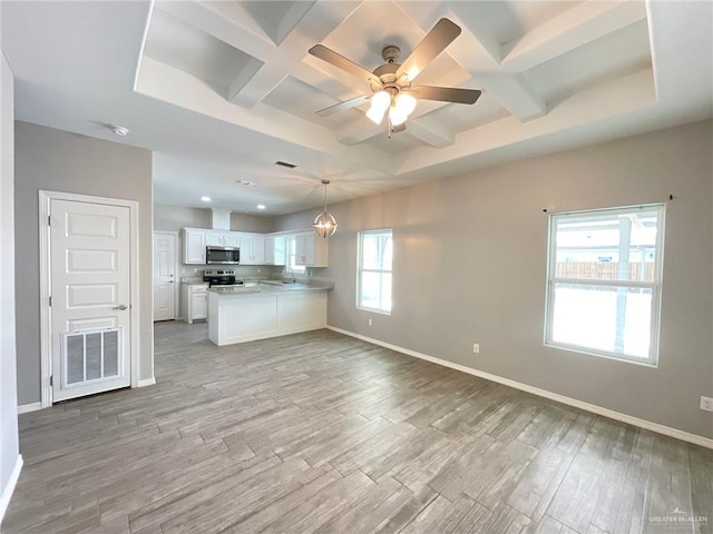2108 Davenport St, Weslaco, TX 78596 - unfurnished living room with coffered ceiling, light wood-type flooring, baseboards, ceiling fan, and beamed ceiling