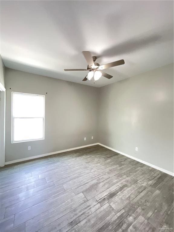 2108 Davenport St, Weslaco, TX 78596 - unfurnished room featuring a ceiling fan, dark wood-type flooring, and baseboards