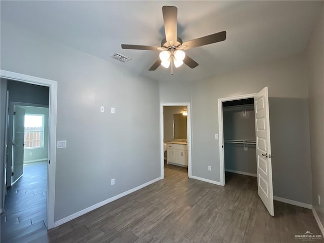 2108 Davenport St, Weslaco, TX 78596 - unfurnished bedroom with baseboards, dark wood-style floors, a closet, and a ceiling fan