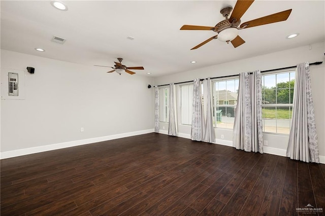 empty room with ceiling fan and dark hardwood / wood-style flooring