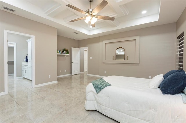 bedroom featuring ceiling fan, ensuite bath, and coffered ceiling